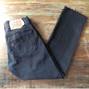 Black Levi’s 501 cropped jeans with frayed hem
